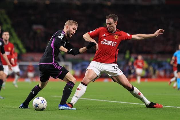 Football - UEFA Champions League - Group A - Manchester United, ManU v Bayern Munich 12th December 2023 - UEFA Champions League - Group A - Manchester United v Bayern Munich - Konrad Laimer of Bayern Munich is tackles by Jonny Evans of Manchester United - Photo: Simon Stacpoole Offside. Manchester UK Copyright: xSimonxStacpoolexOffside