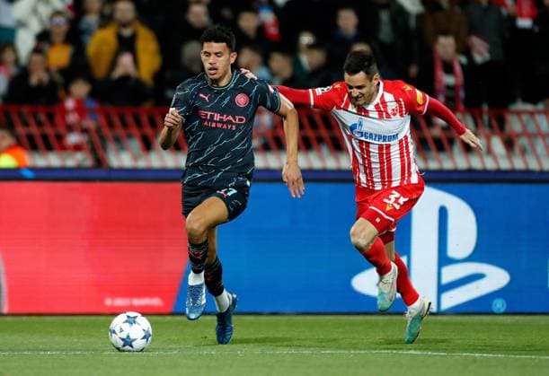 Matheus Nunes of Manchester City is challenged by Milos Degenek of Red Star Crvena zvezda v Manchester City, UEFA Champions League, Group G, Football, Rajko Mitic Stadium, Belgrade, Serbia - 13 Dec 2023 EDITORIAL USE ONLY No use with unauthorised audio, video, data, fixture lists, club league logos or live services. Online in-match use limited to 120 images, no video emulation. No use in betting, games or single club league player publications. Copyright: xNikolaxKrstic Shutterstockx 14254230z