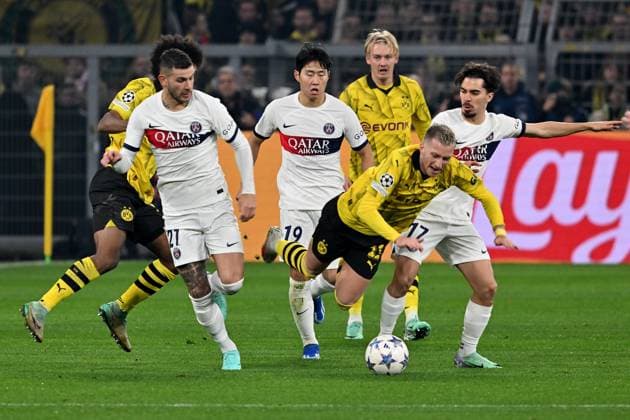 13.12.2023, xsltx, Fussball UEFA Champions League, Borussia Dortmund - Paris St.Germain PSG emspor, v.l. Lucas Hernandez (FC Paris Saint-Germain) Kang-in Lee (FC Paris Saint-Germain) Marco Reus (Borussia Dortmund) Vitinha (FC Paris Saint-Germain) Zweikampf, Aktion, action, battle for the ball (DFL DFB REGULATIONS PROHIBIT ANY USE OF PHOTOGRAPHS as IMAGE SEQUENCES and or QUASI-VIDEO) Dortmund