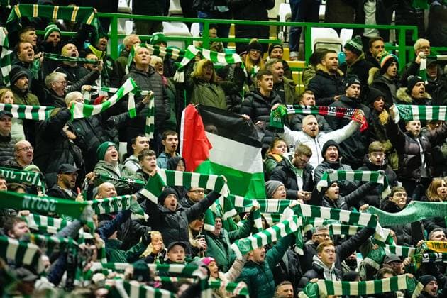 Celtic fans hold up green and white scarves and a Palestine flag. Celtic v Feyenoord, UEFA Champions League, Group E, Football, Celtic Park, Glasgow, UK - 13 Dec 2023 EDITORIAL USE ONLY No use with unauthorised audio, video, data, fixture lists, club league logos or live services. Online in-match use limited to 120 images, no video emulation. No use in betting, games or single club league player publications. Copyright: xStuartxWallace Shutterstockx 14254242aj