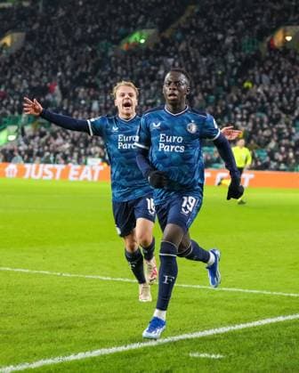 Yankuba Minteh of Feyenoord celebrates scoring to tie the game 1-1, with Thomas van den Belt of Feyenoord, left. Celtic v Feyenoord, UEFA Champions League, Group E, Football, Celtic Park, Glasgow, UK - 13 Dec 2023 EDITORIAL USE ONLY No use with unauthorised audio, video, data, fixture lists, club league logos or live services. Online in-match use limited to 120 images, no video emulation. No use in betting, games or single club league player publications. Copyright: xStuartxWallace Shutterstockx 14254242as
