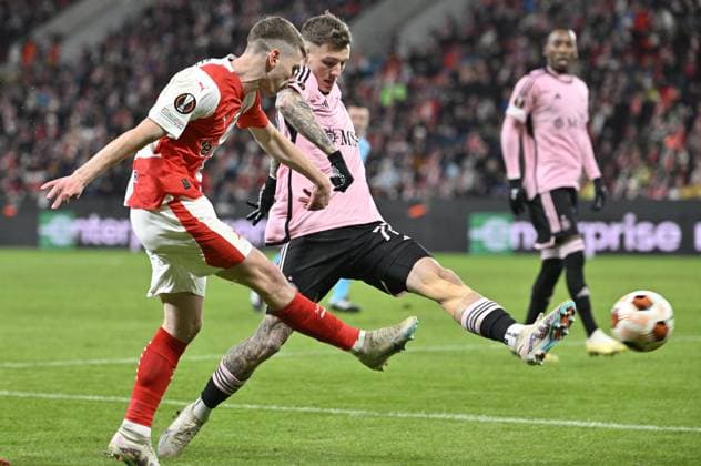 David Doudera of Slavia, left, and Bendeguz Bolla of Servette in action during the UEFA Europa League 6th round Group G football match Slavia Praha vs Servette Geneva in Prague, Czech Republic, December 14, 2023. (CTKxPhoto VitxSimanek) CTKPhotoP2023121407473  CTKPhotoP2023121407473