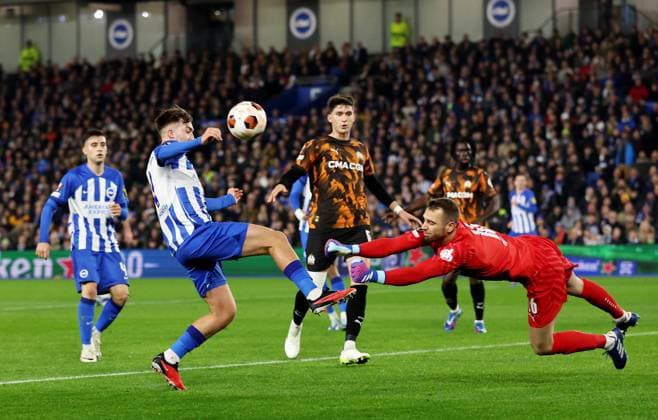 Pau Lopez of Marseille makes a save from Jack Hinshelwood of Brighton & Hove Albion. Brighton & Hove Albion v Marseille, UEFA Europa League, Group A, Football, American Express Community Express Stadium, Brighton, UK - 14 Dec 2023 EDITORIAL USE ONLY No use with unauthorised audio, video, data, fixture lists, club league logos or live services. Online in-match use limited to 120 images, no video emulation. No use in betting, games or single club league player publications. Copyright: xJamesxMarsh Shutterstockx 14254279r