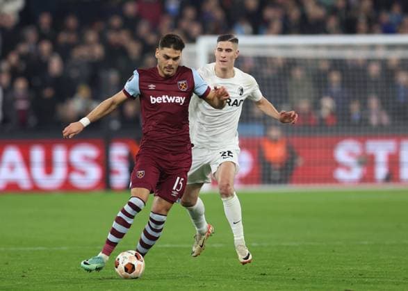 London, England, 14th December 2023. Konstantinos Mavropanos of West Ham United drifts across Roland Sallai of SC Freiburg during the UEFA Europa League match at the London Stadium, London. Picture credit should read: David Klein Sportimage EDITORIAL USE ONLY. No use with unauthorised audio, video, data, fixture lists, club league logos or live services. Online in-match use limited to 120 images, no video emulation. No use in betting, games or single club league player publications. SPI-2801-0021