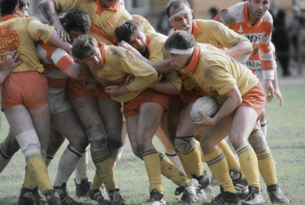 June 1-20, 1990. Moscow, USSR. Rugby players of Slava sports club (in yellow uniform) fight for the ball during a game. The exact date and location of the photograph is unknown. Igor Utkin TASS  19121066