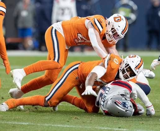 December 24, 2023, Denver, Colorado, USA: Patriots RB EZEKIEL ELLIOT gets gang tackled by the Broncos Defense during the 2nd. Half Sunday night at Empower Field at Mile High in Denver, CO. The Patriots beat the Broncos 26-23. Denver USA - ZUMAav4_ 20231224_zaf_av4_006 Copyright: xHectorxAcevedox