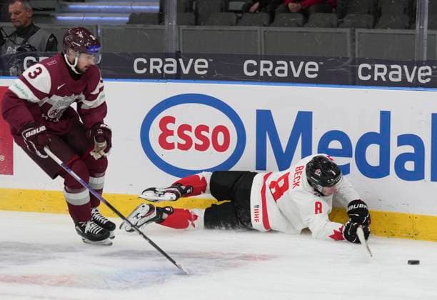 December 27, 2023, GOTHENBURG, SWEDEN: Canada s Owen Beck (8) trips up in the boards as he battles for the puck with Latvia s Viktors Kurbaka (3) during second period hockey action at the IIHF World Junior Hockey Championship in Gothenburg, Sweden on Wednesday, Dec. 27, 2023. Canada News - December 27, 2023  - ZUMAc35_ 20231227_zaf_c35_020 Copyright: xChristinnexMuschix
