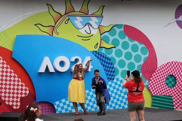 (240113) -- MELBOURNE, Jan. 13, 2024 -- People pose for photos during the Kids Tennis Day at Melbourne Park in Melbourne, Australia, Jan. 13, 2024. The Kids Tennis Day provides activities and entertainment for kids and families. The 2024 Australian Open will be held from Jan. 14 to 28. (Photo by Xinhua) (SP)AUSTRALIA-MELBOURNE-TENNIS-AUSTRALIAN OPEN-KIDS TENNIS DAY ChuxChen 