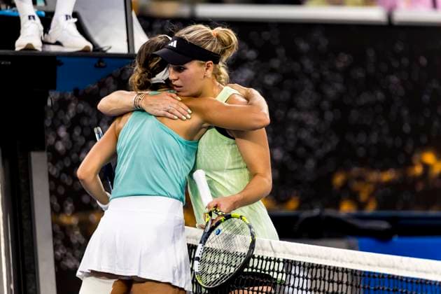 MELBOURNE, VIC - JANUARY 14: Caroline Wozniacki of Denmark consoles Magda Linette of Poland after her retirement of the match during Round 1 of the 2024 Australian Open on January 14 2024, at Melbourne Park in Melbourne, Australia. (Photo by Jason Heidrich Icon Sportswire) TENNIS: JAN 14 Australian Open EDITORIAL USE ONLY Icon240114206