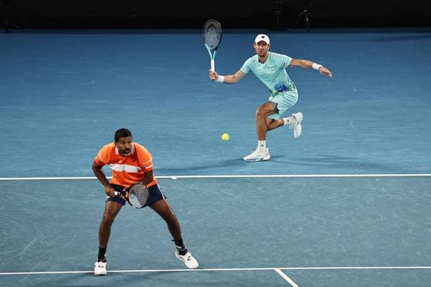 Rohan Bopanna (orange), IND, and Matthew Ebden, AUS, during mens doubles of 2024 Australian Open in Melbourne, 25 01 2023; -
