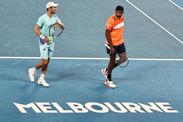 Rohan Bopanna (orange), IND, and Matthew Ebden, AUS, during mens doubles of 2024 Australian Open in Melbourne, 25 01 2023; -