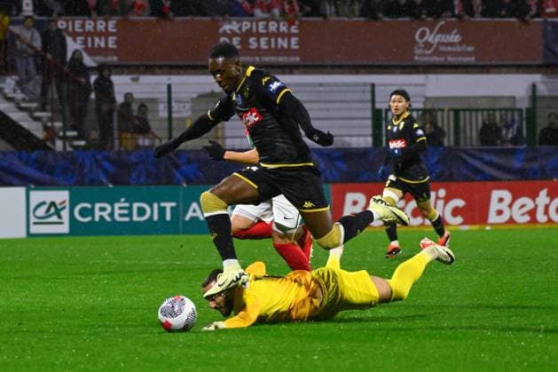 Balogun Folarin ( 9 - Monaco ) and Aggoune Leonard ( 1 - Rouen ) during the French Cup match between Quevilly Rouen Metropole and AS Monaco at Stade Robert Diochon on February 08, 2024 in Rouen, France. ( Photo by federico pestellini panoramic ) - FOOTBALL : Rouen vs Monaco - Coupe de France - 08 02 2024 FedericoPestellini Panoramic 