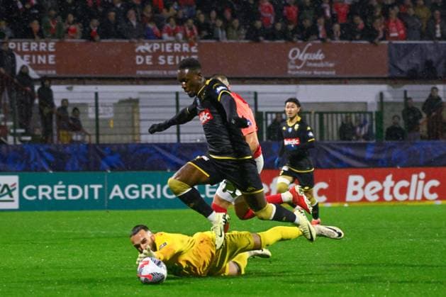 Balogun Folarin ( 9 - Monaco ) and Aggoune Leonard ( 1 - Rouen ) during the French Cup match between Quevilly Rouen Metropole and AS Monaco at Stade Robert Diochon on February 08, 2024 in Rouen, France. ( Photo by federico pestellini panoramic ) - FOOTBALL : Rouen vs Monaco - Coupe de France - 08 02 2024 FedericoPestellini Panoramic 
