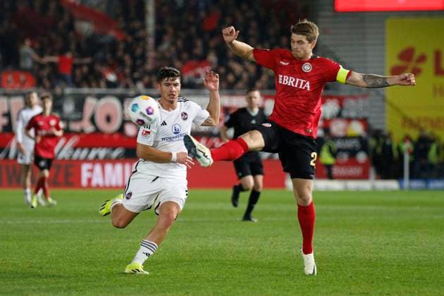 09.02.2024, xavx, Fussball 2.Bundesliga, SV Wehen Wiesbaden - 1.FC Nürnberg emspor, v.l. Taylan Duman (1.FC Nürnberg), Marcus Mathisen (SV Wehen Wiesbaden) (DFL DFB REGULATIONS PROHIBIT ANY USE OF PHOTOGRAPHS as IMAGE SEQUENCES and or QUASI-VIDEO) Wiesbaden