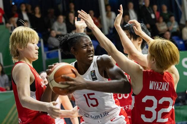 (240212) -- SOPRON, Feb. 12, 2024 -- Laeticia Amihere (C) of Canada vies with Takada Maki (L) of Japan and Miyazaki Saori of Japan during the match between Canada and Japan at the FIBA Women s Olympic qualifying tournament in Sopron, Hungary on Feb. 11, 2024. (Photo by Xinhua) (SP) HUNGARY-SOPRON-BASKETBALL-FIBA WOMEN S OLYMPIC QUALIFIERS-CANADA VS JAPAN AttilaxVolgyi 