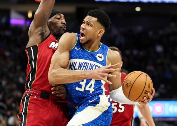 (240214) -- MILWAUKEE, Feb. 14, 2024 -- Milwaukee Bucks forward Giannis Antetokounmpo (R) goes to the basket during the 2023-2024 NBA, Basketball Herren, USA regular season game between the Miami Heat and the Milwaukee Bucks at Fiserv Forum in Milwaukee, the United States, on Feb. 13, 2024. (Photo by Joel Lerner Xinhua) (SP)U.S.-MILWAUKEE-BASKETBALL-NBA-BUCKS VS HEAT XuxJing 