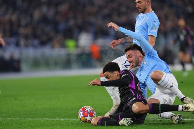 UEFA CHAMPIONS LEAGUE 2023-2024 - Round 16 - SS Lazio vs Bayern Munchen, Olympic Stadium in Rome Rome, Italy 14.2.2024: Jamal Musiala of Bayern Munchen, Maria Gila of Lazio in action during the Uefa Champions League 2023-2024, round of 16 football match SS Lazio vs FC Bayern Mucnhen at Olympic Stadium in Rome. Rome Olympic italy italy Copyright: xmarcoxiacobucci