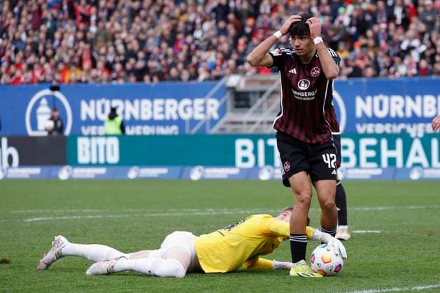 Bild: v. li. Torwart Julian Krahl (1.FC Kaiserslautern, 18) und Can Uzun (1.FC Nuernberg, 42). 18.02.2024, Fussball, 2. Bundesliga, 1. FC Nuernberg - 1. FC Kaiserslautern, GER, Nuernberg, Max-Morlock-Stadion DFL REGULATIONS PROHIBIT ANY USE OF PHOTOGRAPHS AS IMAGE SEQUENCES AND OR QUASI-VIDEO.
