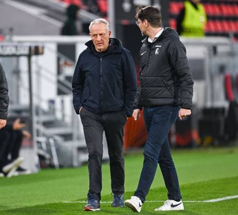 Germany, Freiburg, 22.02.2024, Europa-Park Stadion, SC Freiburg vs RC Lens - UEFA Europa League, Trainer Christian Streich (SC Freiburg) walks with Pressesprecher Sascha Glunk (SC Freiburg) to an interview Freiburg Europa-Park Stadion Baden-Wuerttemberg Germany
