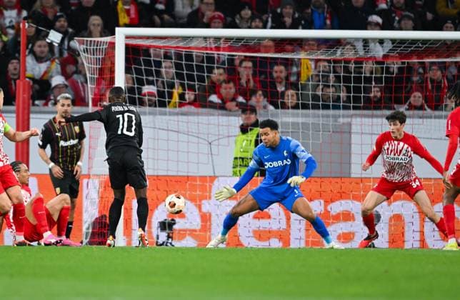 Germany, Freiburg, 22.02.2024, Europa-Park Stadion, SC Freiburg vs RC Lens - UEFA Europa League, David Costa (RC Lens) scores against Noah Atubolu (SC Freiburg) the first goal for his team Freiburg Europa-Park Stadion Baden-Wuerttemberg Germany