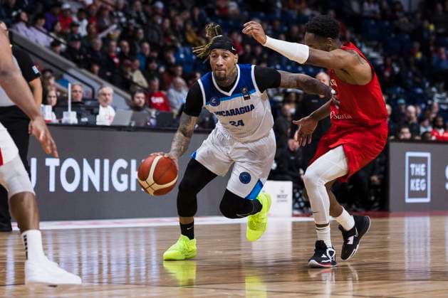 February 23, 2024, St. Catharines, On, Canada: Jared Ruiz (24) of Nicaragua carries the ball past Aaron Best (1) of Canada during first half FIBA AmeriCup qualification play in St. Catharines, Ont., Friday, February 23, 2024. Canada News - February 23, 2024  - ZUMAc35_ 20240223_zaf_c35_166 Copyright: xNickxIwanyshynx