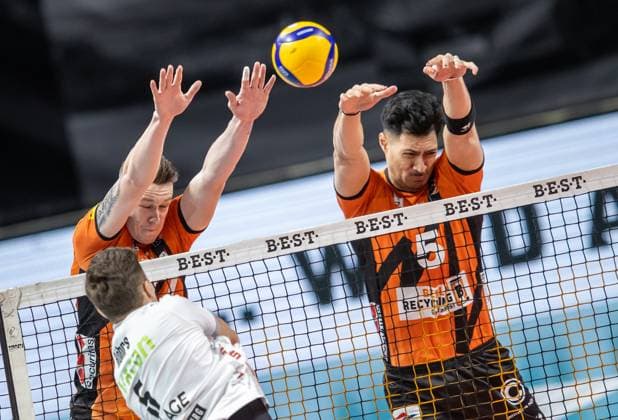 24.02.2024, Berlin, Volleyball: 1.Bundesliga, Maenner, 21. Spieltag, BR Volleys - SVG Lueneburg, Max-Schmeling-Halle. Erik Roehrs (l-r) von SVG Lueneburg spielt den Ball gegen Berlins Block aus Marek Sotola und Nehemiah Mote. BR Volleys - SVG Lueneburg