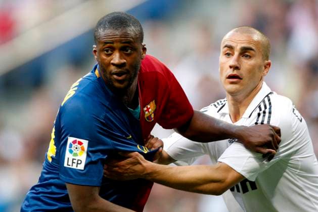 Onderwerp Subject: Real Madrid - FC Barcelona, Barca Primera Division Reklame: Club Team Country: Real Madrid - FC Barcelona Seizoen Season: 2008 2009 FOTO PHOTO: Real Madrid s Fabio CANNAVARO (R) in duel with FC Barcelona s Yaya TOURE (L) MADRID ESP Content not available for redistribution in The Netherlands directly or indirectly through any third parties. Copyright: xBSRxAgencyx 09690502MKL0014