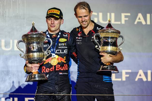 (240303) -- SAKHIR, March 3, 2024 -- First-placed Red Bull Racing s driver Max Verstappen (L) of the Netherlands and Red Bull team engineer Tom Hart hold trophies on the podium during the awarding ceremony for the Bahrain Formula One Grand Prix at the Bahrain International Circuit in Sakhir, Bahrain, on March 2, 2024. (Photo by Qian Jun Xinhua) (SP)BAHRAIN-SAKHIR-FORMULA 1 GRAND PRIX-FINAL WangxHaizhou 