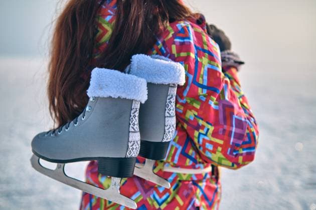 A woman holds skates on her shoulder after skiing on a frozen lake A woman in a ski suit holds skates on her shoulder, after skiing on a frozen lake, closeup (License=RF) 17588365 ,model released, Symbolfoto Copyright: xZoonar.com SergeyxNepshax 17588365 ,model released, Symbolfoto ,property released