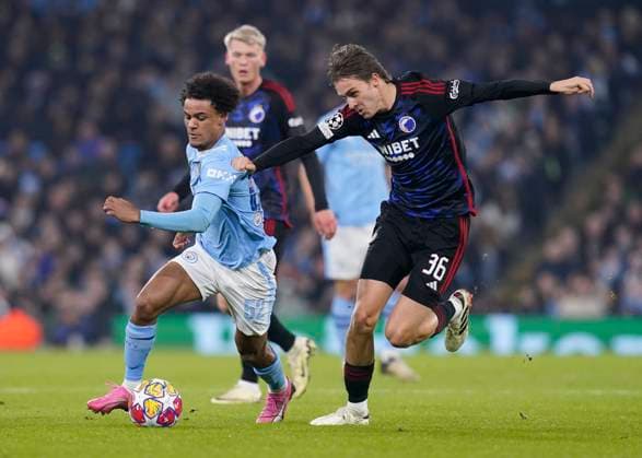 MANCHESTER, ENGLAND, 6th March 2024. Oscar Bobb of Manchester City and William Clem of FC Copenhagen challenge for the ball during the UEFA Champions League match at the Etihad Stadium, MANCHESTER. Picture credit should read: Andrew Yates Sportimage EDITORIAL USE ONLY. No use with unauthorised audio, video, data, fixture lists, club league logos or live services. Online in-match use limited to 120 images, no video emulation. No use in betting, games or single club league player publications. SPI-2988-0044