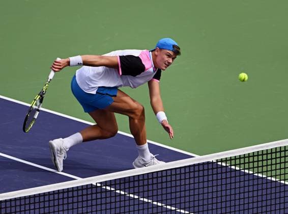 INDIAN WELLS, CA - MARCH 11: Holger Rune (DEN) charges the net to return the ball during an ATP, Tennis Herren tennis match played on March 11, 2024 during the BNP Paribas Open played at the Indian Wells Tennis Garden in Indian Wells, CA. (Photo by John Cordes Icon Sportswire) TENNIS: MAR 11 BNP Paribas Open EDITORIAL USE ONLY Icon506240311013