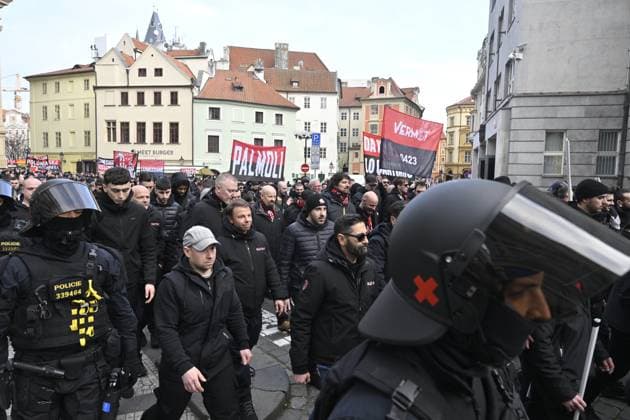 Police officers supervise fans gathering before the march to the match Slavia Praha vs AC Milan, the return match of the Europa League semi-final football match, on March 14, 2024, in Old Town Square, Prague, Czech Republic. (CTKxPhoto VitxSimanek) CTKPhotoP2024031406246  CTKPhotoP2024031406246
