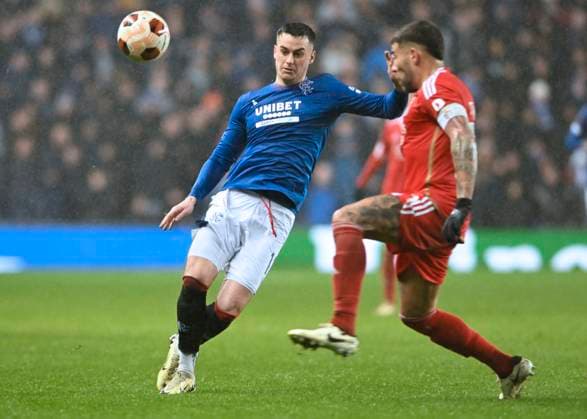 Glasgow, Scotland, 14th March 2024. Tom Lawrence of Rangers and Nicol‡s Otamendi of Benfica during the UEFA Europa League Round of 16 match at Ibrox Stadium, Glasgow. Picture credit should read: Neil Hanna Sportimage EDITORIAL USE ONLY. No use with unauthorised audio, video, data, fixture lists, club league logos or live services. Online in-match use limited to 120 images, no video emulation. No use in betting, games or single club league player publications. SPI-3007-0018