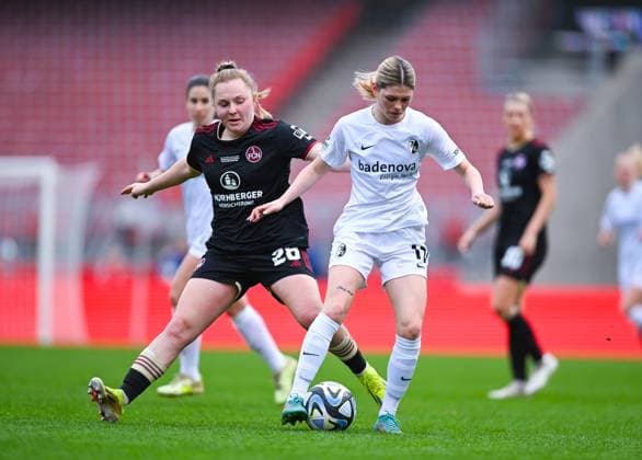 Germany, Nuernberg, 17.03.2024, Max-Morlock-Stadion, 1. FC Nuernberg vs SC Freiburg - Frauen-Bundesliga, Eileen Campbell (SC Freiburg) und Madeleine Steck (1. FC Nuernberg) battle for the ball Nuremberg Max-Morlock-Stadion Bavaria Germany
