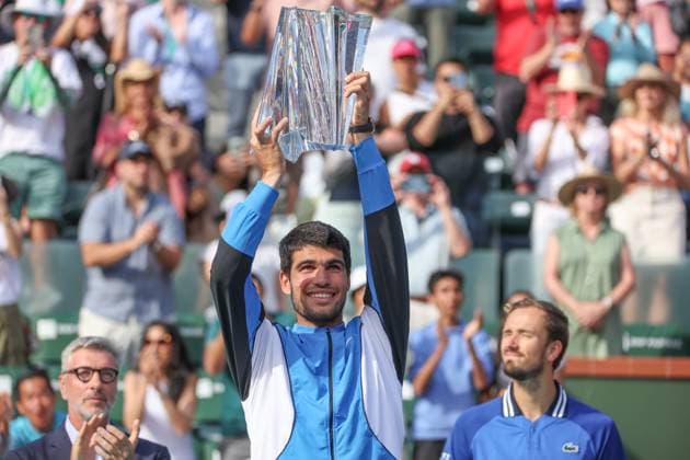 INDIAN WELLS, CA - MARCH 17: Carlos Alcaraz (ESP) poses with the trophy after winning the menÕs singles final of the BNP Paribas Open on March 17, 2024 at Indian Wells Tennis Garden in Indian Wells, CA. (Photo by George Walker Icon Sportswire) TENNIS: MAR 17 BNP Paribas Open EDITORIAL USE ONLY Icon240317064