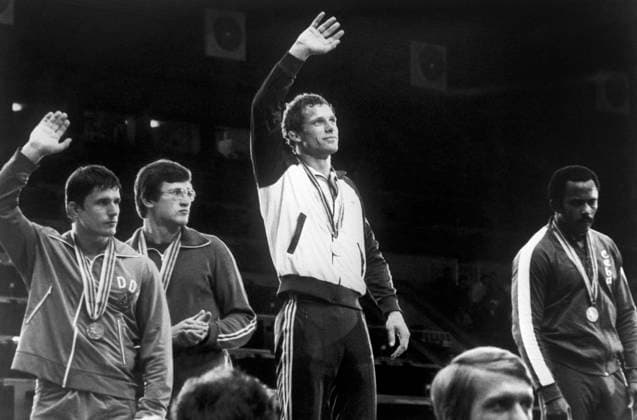 Moscow, USSR. Judo wrestlers Detlef Ulch (GDR, bronze), Alexander Yatskevich (USSR, bronze), Jurg Roethlisberger (Switzerland, gold) and Isaac Azcuy (Cuba, silver) (L-R) stand on the Olympic podium during the awarding ceremony of of the judo of the the weight category up to 86 kilograms medalists of the 1980 Summer Olympics in the Palace of Sports of the Lenin Stadium. Givi Kikvadze, Alexander Chumichev TASS  11354925