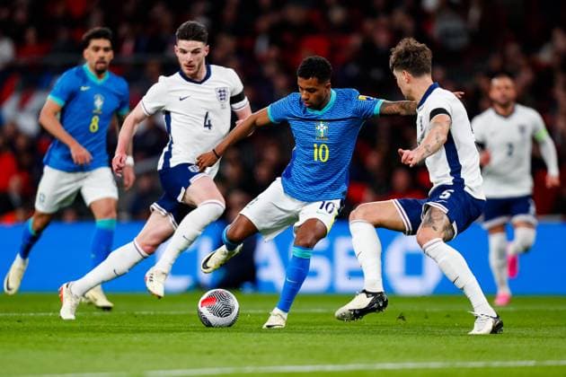 23rd March 2024; Wembley Stadium, London, England; International Football Friendly, England versus Brazil; Rodrygo of Brazil attempts to shoot under pressure from John Stones of England  ActionPlus12621265 GrahamxWilson