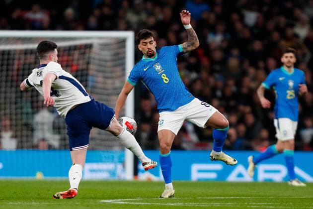 23rd March 2024; Wembley Stadium, London, England; International Football Friendly, England versus Brazil; Declan Rice of England tackles Bruno Guimaraes of Brazil  ActionPlus12621279 GrahamxWilson