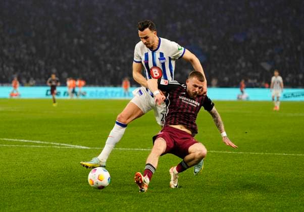 Germany, Berlin, 30.03.2024, Olympic Stadium, Hertha BSC vs 1.FC Nürnberg - 2. Bundesliga, Haris Tabakovic (Hertha Berlin) and Jannes Horn (1.FC Nürnberg) battle for the ball Berlin Olympic Stadium Berlin Germany
