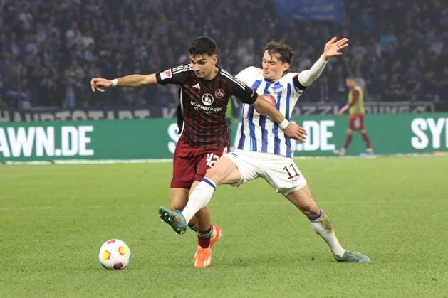 DEU, DFL, 2. FBL, Hertha BSC vs. 1.FC Nuernberg, 30.03.2024, Berliner Olympiastadion, Berlin, DEU, DFL, 2. FBL, Hertha BSC vs. 1.FC Nuernberg, im Bild Fabian Reese (Hertha BSC Berlin 11), Can Yilmaz Uzun (1.FC Nuernberg 42) DFL - regulations prohibit any use of Photographs as image sequences and or quasi-video Foto: Juergen Engler nordphoto GmbH