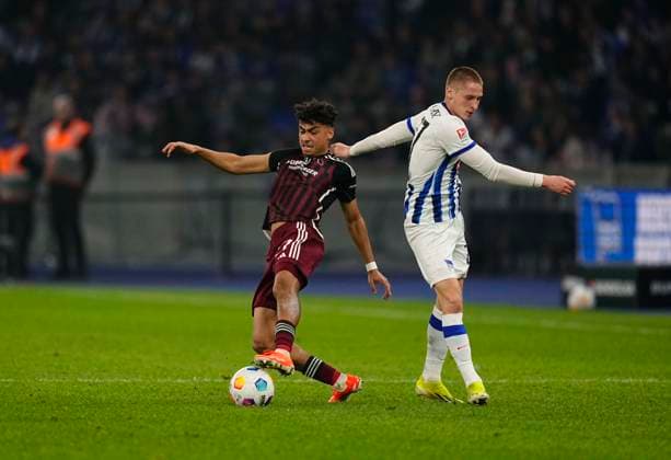Germany, Berlin, 30.03.2024, Olympic Stadium, Hertha BSC vs 1.FC Nürnberg - 2. Bundesliga, Palko Dardai (Hertha Berlin) and Nathaniel Brown (1.FC Nürnberg) battle for the ball Berlin Olympic Stadium Berlin Germany