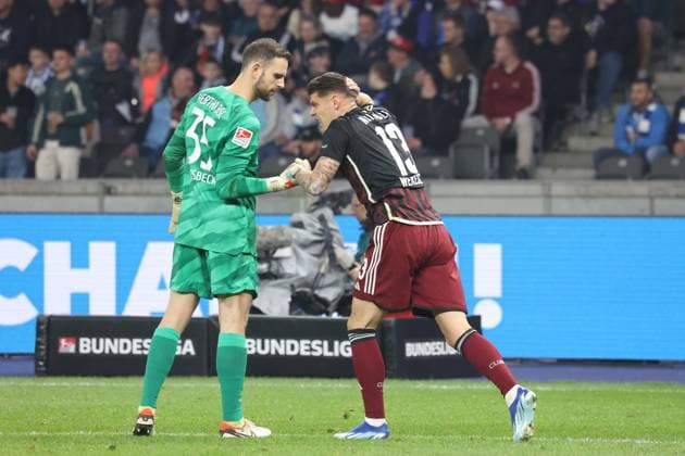 DEU, DFL, 2. FBL, Hertha BSC vs. 1.FC Nuernberg, 30.03.2024, Berliner Olympiastadion, Berlin, DEU, DFL, 2. FBL, Hertha BSC vs. 1.FC Nuernberg, im Bild Marius Gersbeck (Hertha BSC Berlin 35), Erik Wekesser (1.FC Nuernberg 13) DFL - regulations prohibit any use of Photographs as image sequences and or quasi-video Foto: Juergen Engler nordphoto GmbH