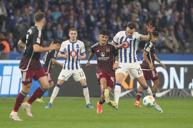 30.03.2024, xtgx, Fussball - 2.Bundesliga, Hertha BSC Berlin - 1.FC Nuernberg emspor, v.l. Can Yilmaz Uzun (Nuernberg, 42), Haris Tabakovic (Hertha, 25) Zweikampf, Duell, Kampf, tackle (DFL DFB REGULATIONS PROHIBIT ANY USE OF PHOTOGRAPHS as IMAGE SEQUENCES and or QUASI-VIDEO) Berlin