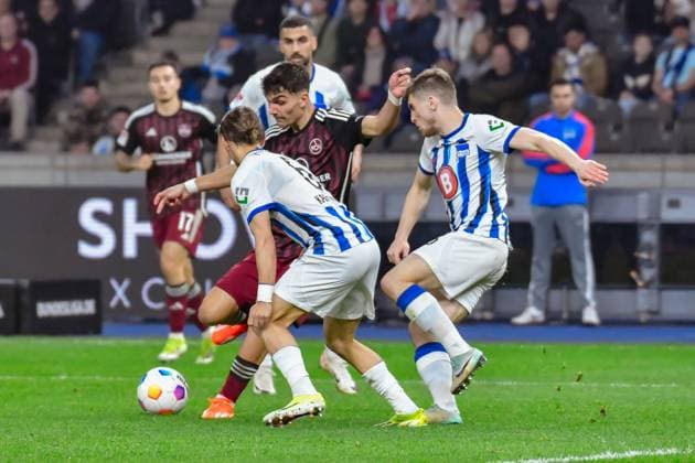 30.03.2024, xlakx, Fussball 2. Bundesliga, Hertha BSC - 1.FC Nuernberg emspor, v.l.Can Yilmaz Uzun (1.FC Nuenberg 42),Michal Karbownik (Hertha BSC 6),Jonjoe Kenny (Hertha BSC 16),Zweikampf, Duell, Kampf, tackle (DFL DFB REGULATIONS PROHIBIT ANY USE OF PHOTOGRAPHS as IMAGE SEQUENCES and or QUASI-VIDEO) Berlin