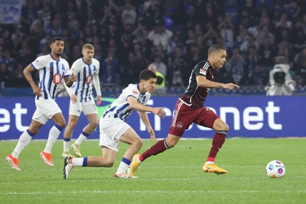 DEU, DFL, 2. FBL, Hertha BSC vs. 1.FC Nuernberg, 30.03.2024, Berliner Olympiastadion, Berlin, DEU, DFL, 2. FBL, Hertha BSC vs. 1.FC Nuernberg, im Bild Ibrahim Maza (Hertha BSC Berlin 30), Jan Gyamerah (1.FC Nuernberg 28) DFL - regulations prohibit any use of Photographs as image sequences and or quasi-video Foto: Juergen Engler nordphoto GmbH