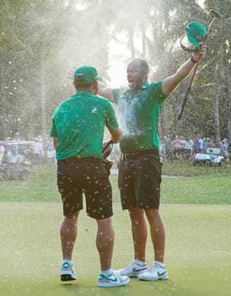 April 7, 2024, Doral, Florida, USA: Lee Oosthuizen (L) sprays individual winner Dean Burmester of Stinger with champagne on the 18th hole after the final round of LIV Golf Miami at Trump National Doral. Doral USA - ZUMAw109 20240407_fap_w109_032 Copyright: xDebbyxWongx