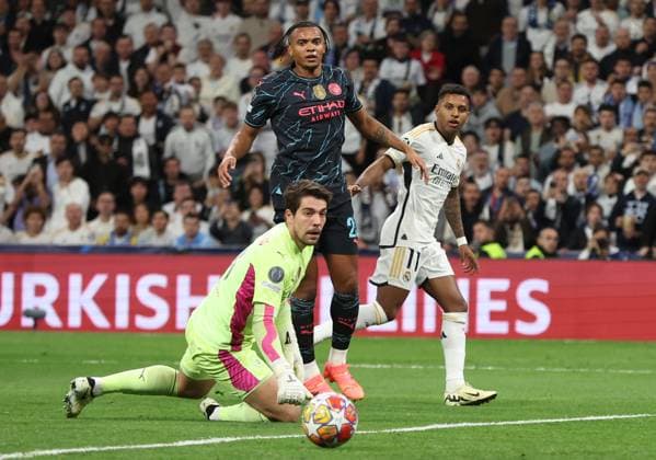 Madrid, Spain, 9th April 2024. Rodrygo of Real Madrid (R) scores their second goal during the UEFA Champions League match at the Santiago Bernabau, Madrid. Picture credit should read: Paul Terry Sportimage EDITORIAL USE ONLY. No use with unauthorised audio, video, data, fixture lists, club league logos or live services. Online in-match use limited to 120 images, no video emulation. No use in betting, games or single club league player publications. SPI-3066-0048