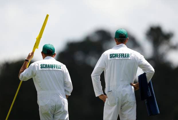 Xander Schauffele s caddie Austin Kaiser (L) stands with Scottie Scheffler s caddie Ted Scott on the fourth hole during the first round of the Masters Tournament at Augusta National Golf Club in Augusta, Georgia on Thursday, April 11, 2024.  AUG20240411133 JOHNxANGELILLO