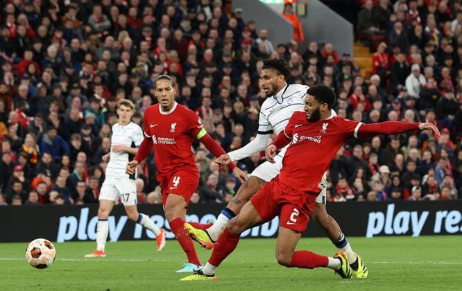 11th April 2024; Anfield, Liverpool, Merseyside, England; Europa League, Quarter Final;, First Leg Football, Liverpool versus Atalanta; Ederson of Atalanta shoots at goal as Joe Gomez of Liverpool attempts to block  ActionPlus12628676 DavidxBlunsden