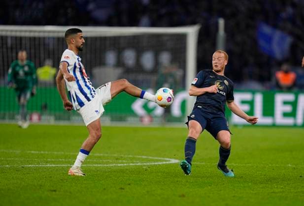 Germany, Berlin, 12.04.2024, Olympic Stadium, Hertha BSC vs FC Hansa Rostock - 2. Bundesliga, Andreas Bouchalakis (Hertha Berlin) and Sebastian Vasiliadis (FC Hansa Rostock) battle for the ball Berlin Olympic Stadium Berlin Germany